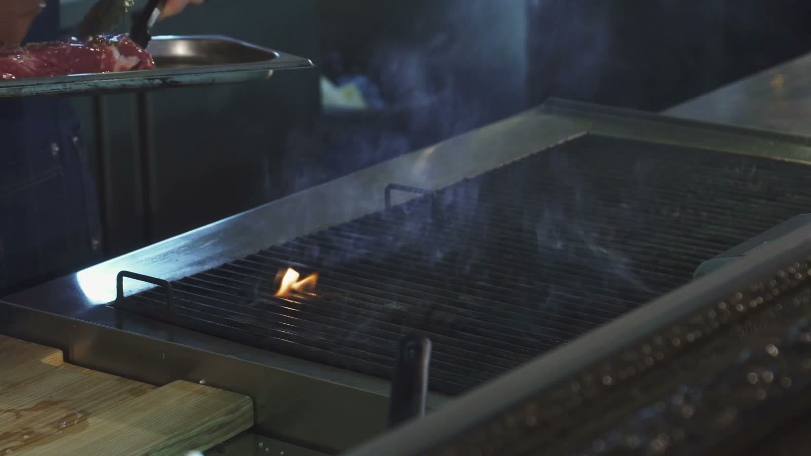 chef-expertly-grilling-steak-in-a-bustling-restaur.mp4
