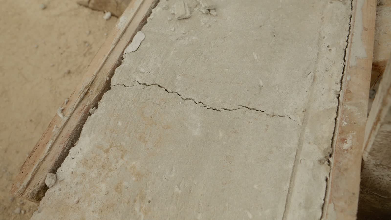 cracked-concrete-slab-with-wood-frame-on-ground.mp4