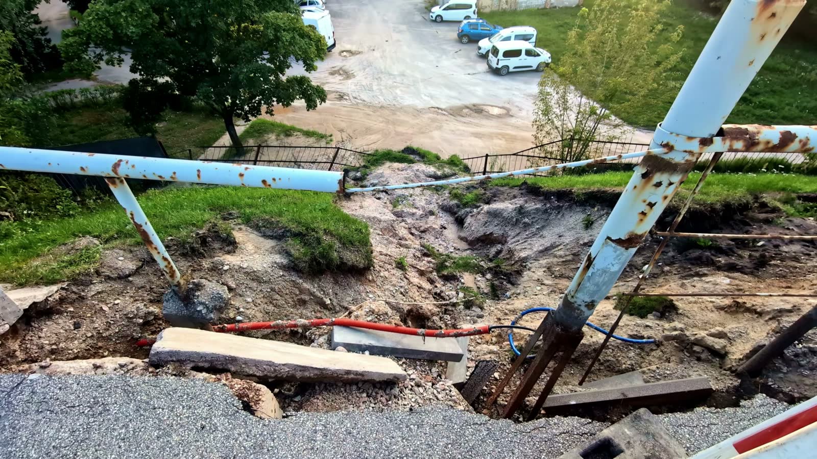 Pavement and ground collapsed where storm erosion undermined the earth beneath