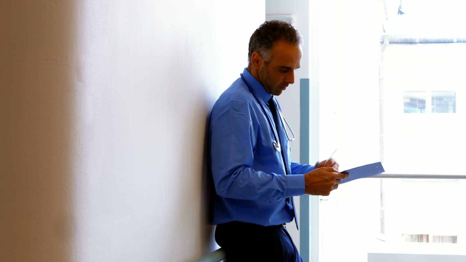 doctor-reviewing-chart-in-hospital-setting.mp4