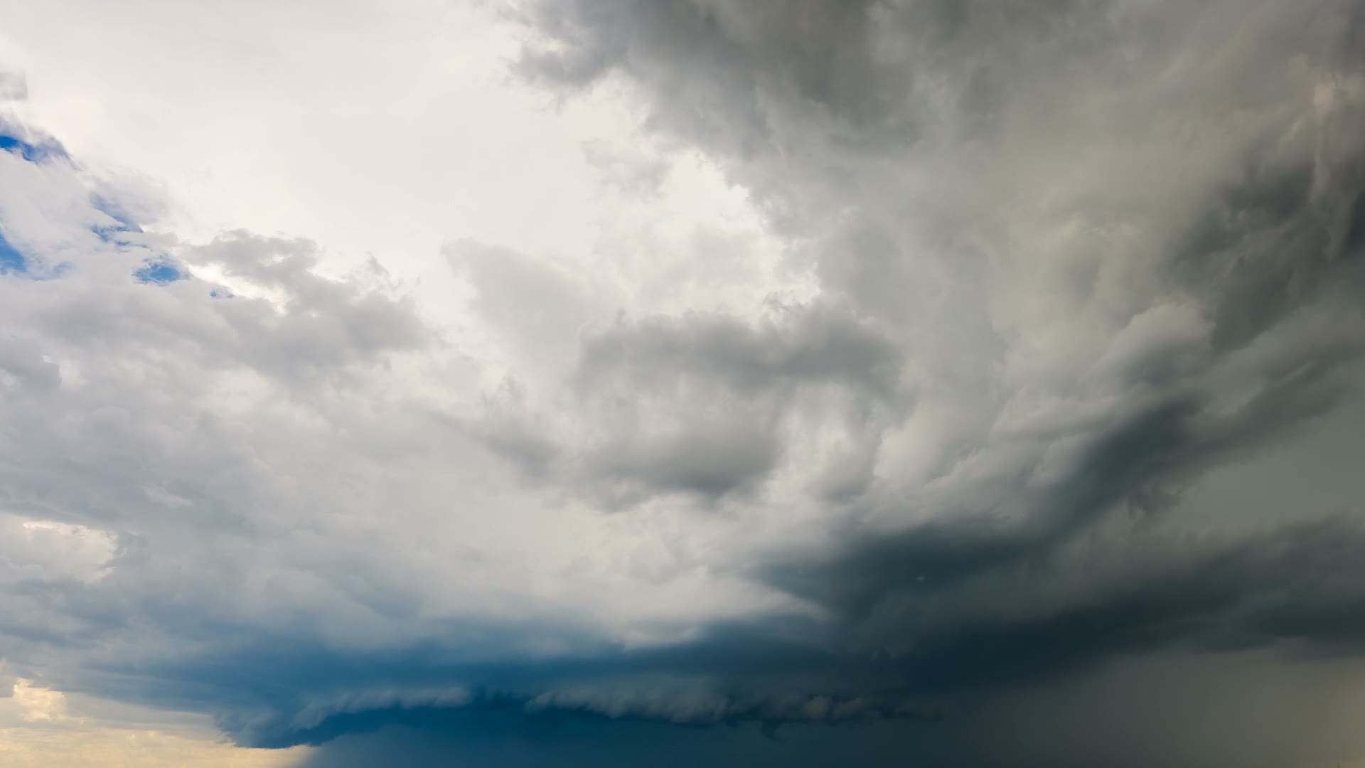dramatic-storm-clouds-rolling-across-blue-sky-land.mp4