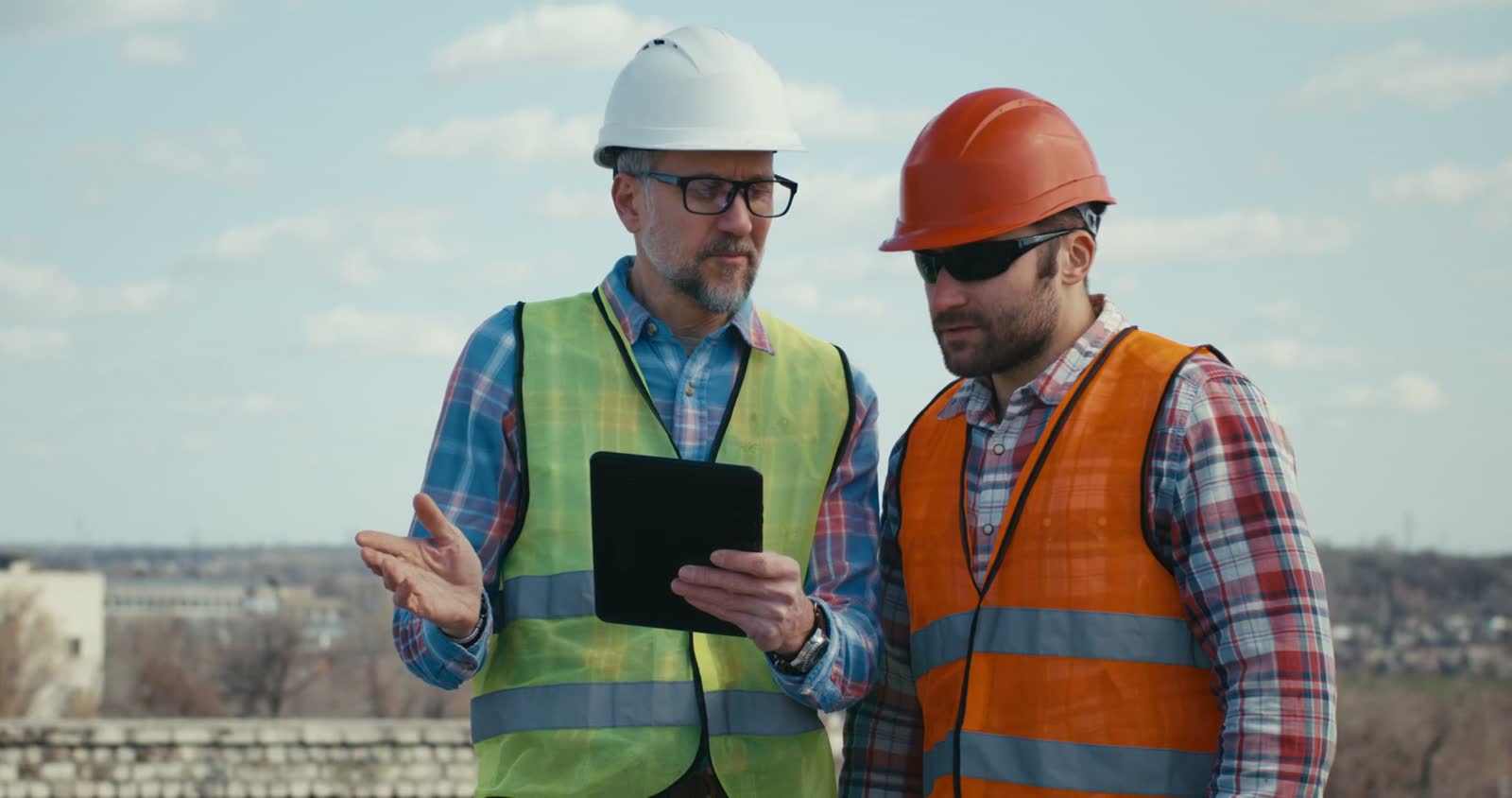 engineers-reviewing-plans-on-tablet-outdoors.mp4