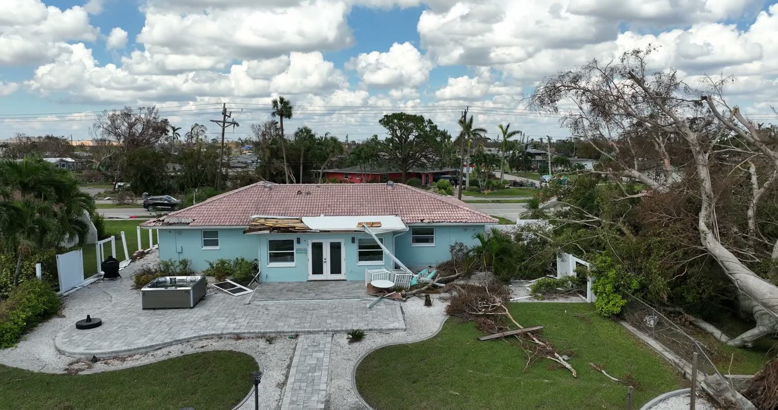 Aerial view of a hurricane-damaged suburban house