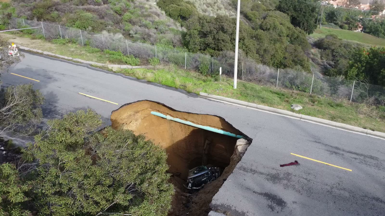 large-sink-hole-forms-in-road.mp4