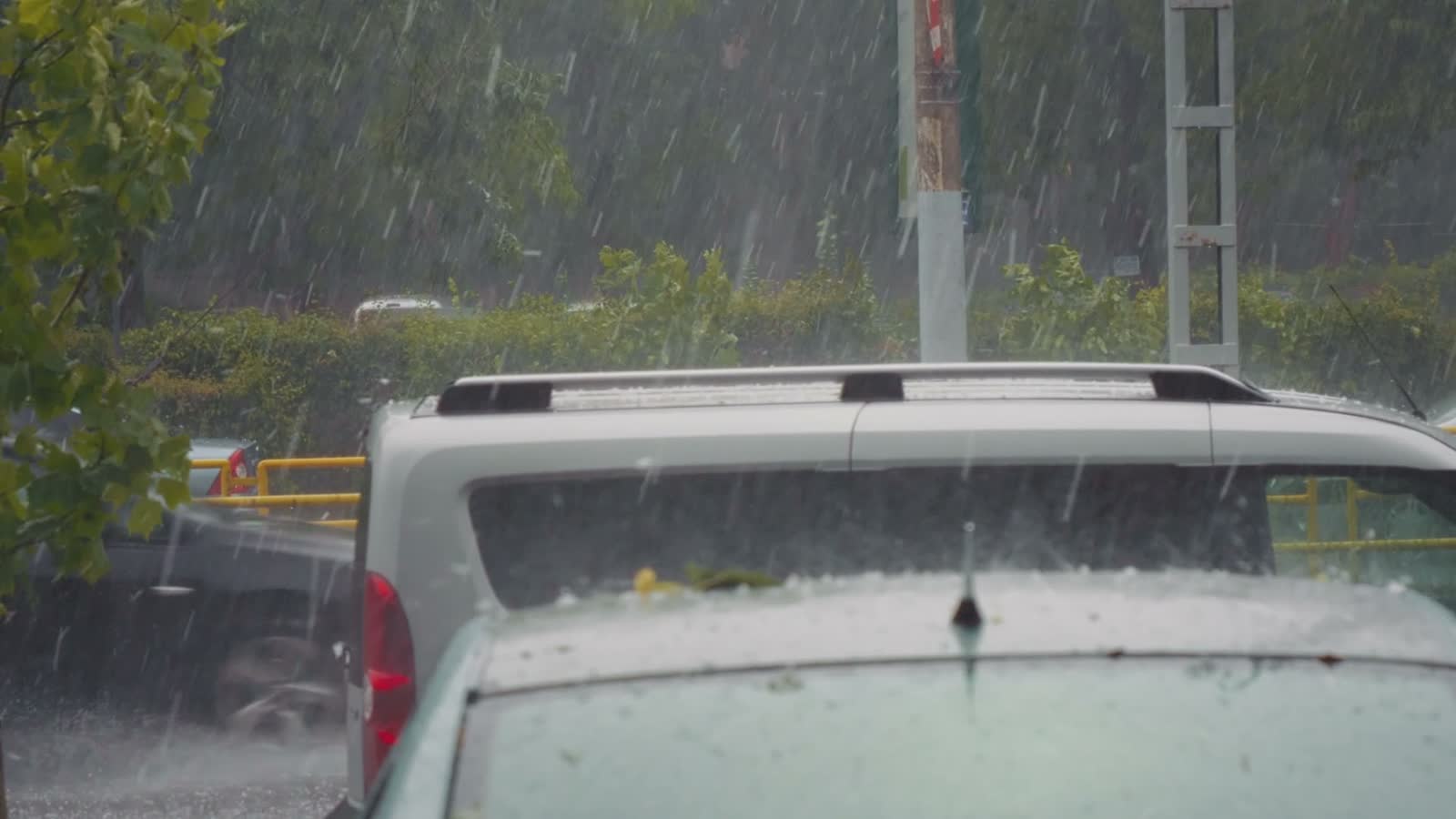 rain-falling-heavily-on-cars-in-city.mp4