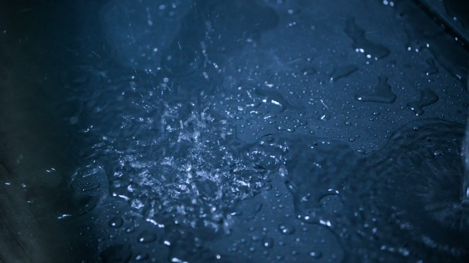 water-pouring-and-splashing-on-blue-surface.mp4