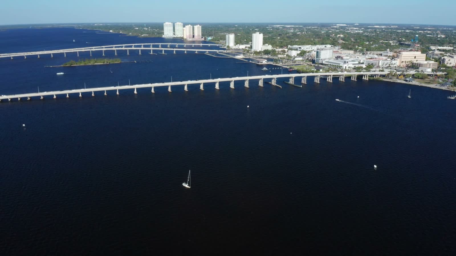 sailboat-navigating-under-expansive-fort-myers-bri.mp4