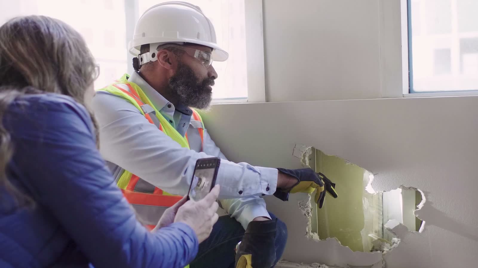 architect-and-construction-foreman-taking-photo-of.mp4
