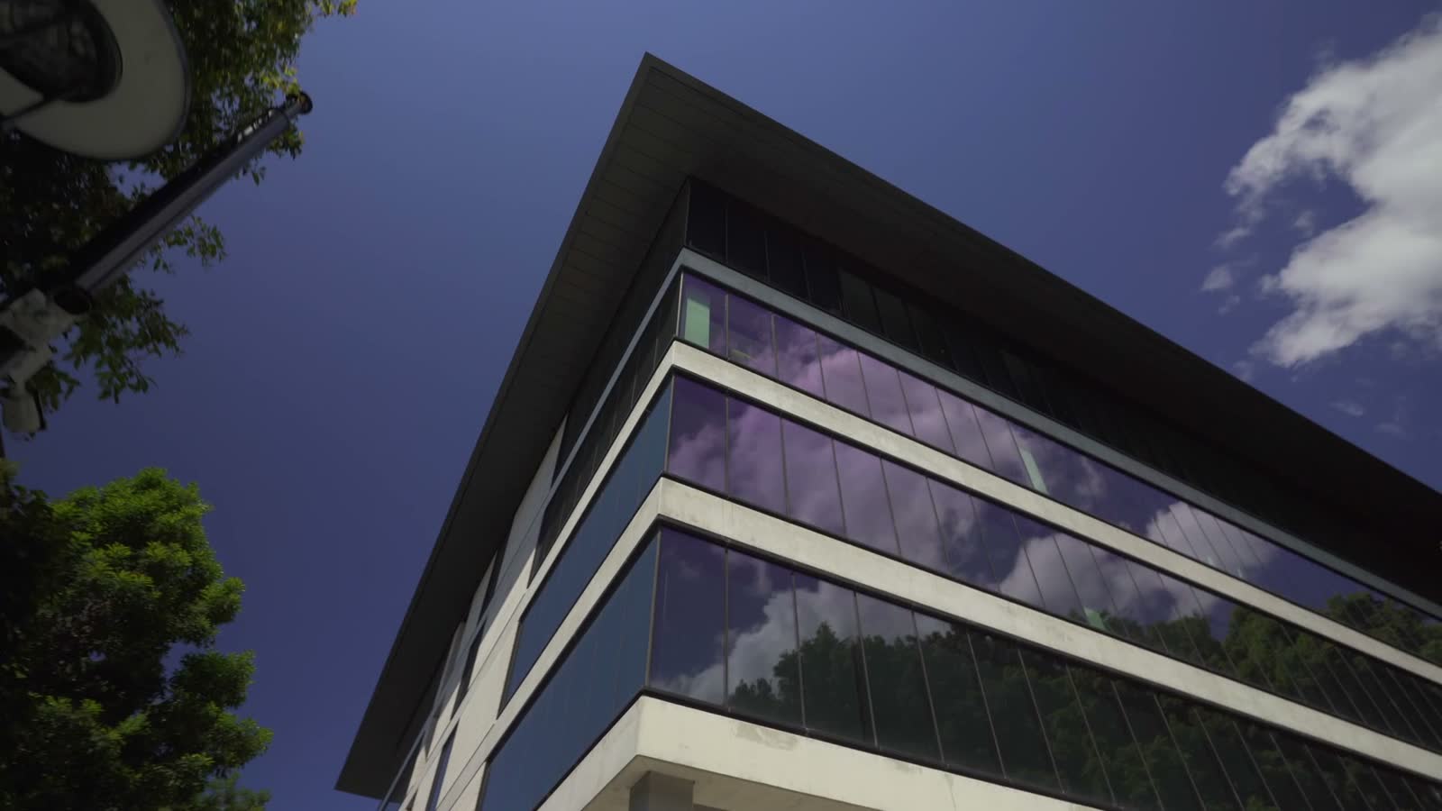 blue-sky-with-cloud-reflecting-on-building-s-windo.mp4