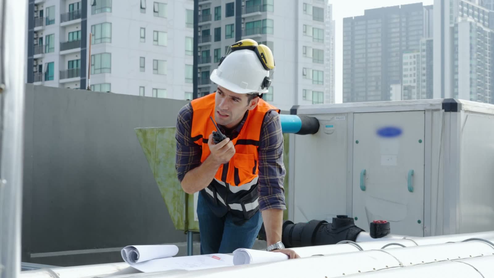 engineer-reviews-blueprints-and-uses-walkie-talkie.mp4