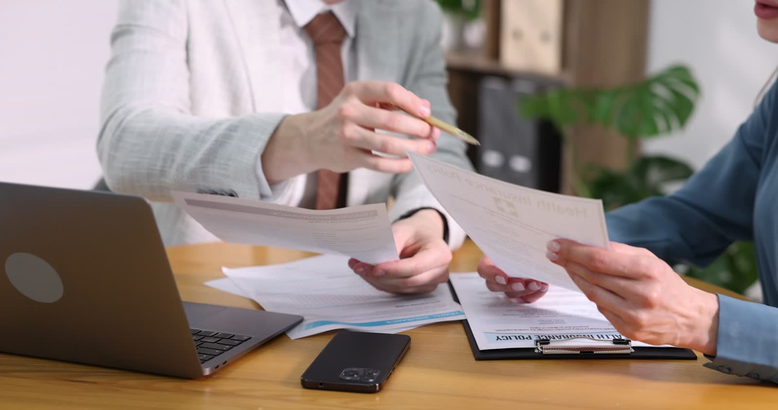 insurance-agents-working-at-table-in-office-close.mp4