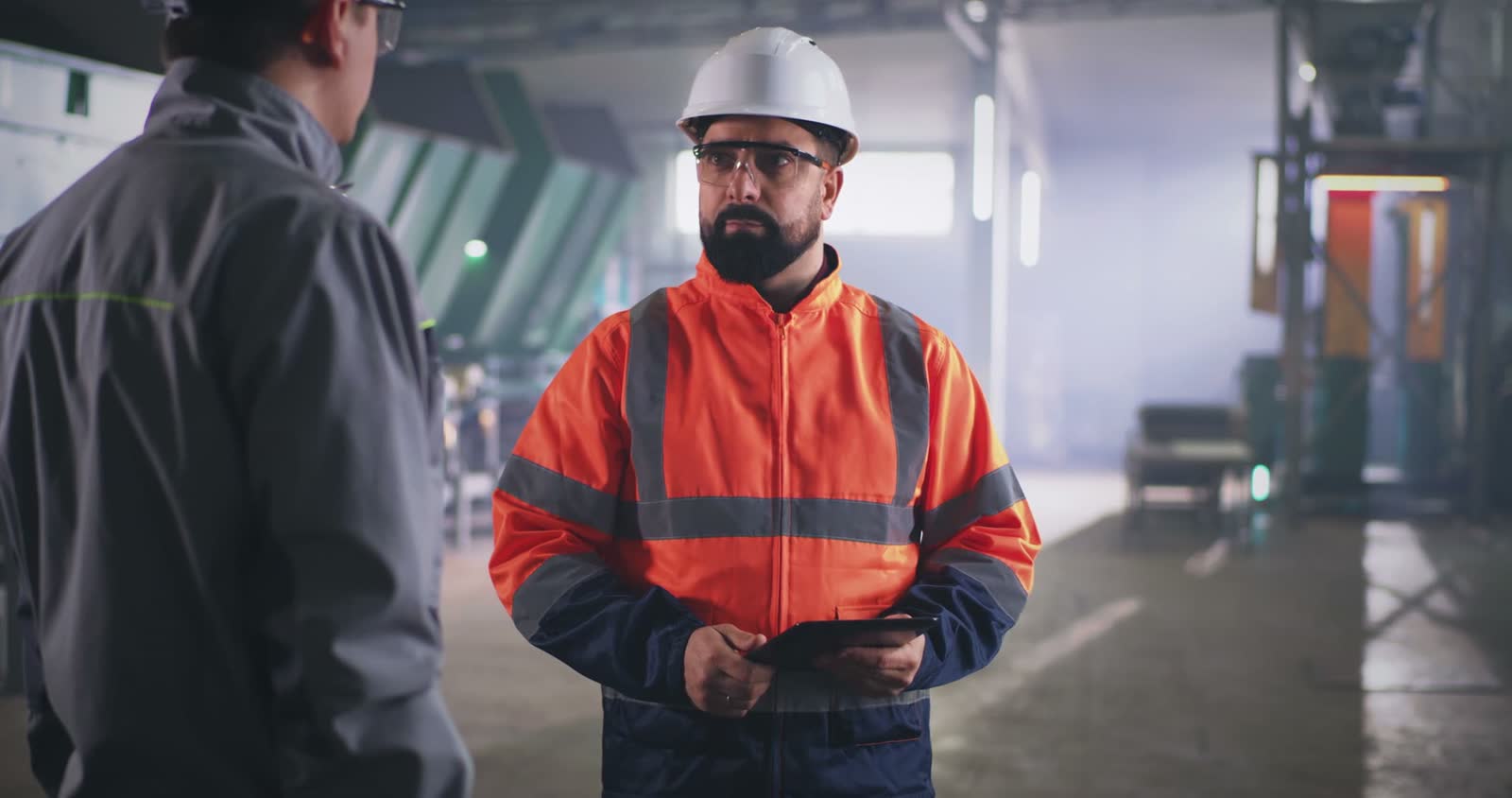 male-inspector-speaking-with-worker-on-factory.mp4