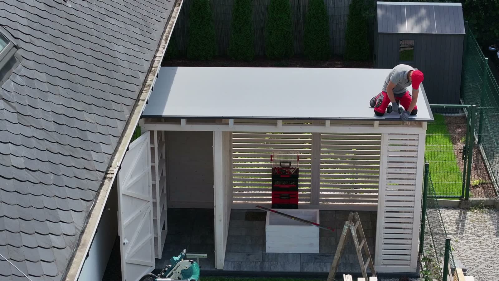 man-constructing-wooden-building-in-suburban-backy.mp4