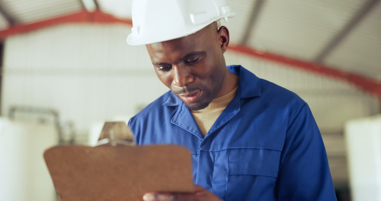 man-reviews-clipboard-in-industrial-workplace.mp4