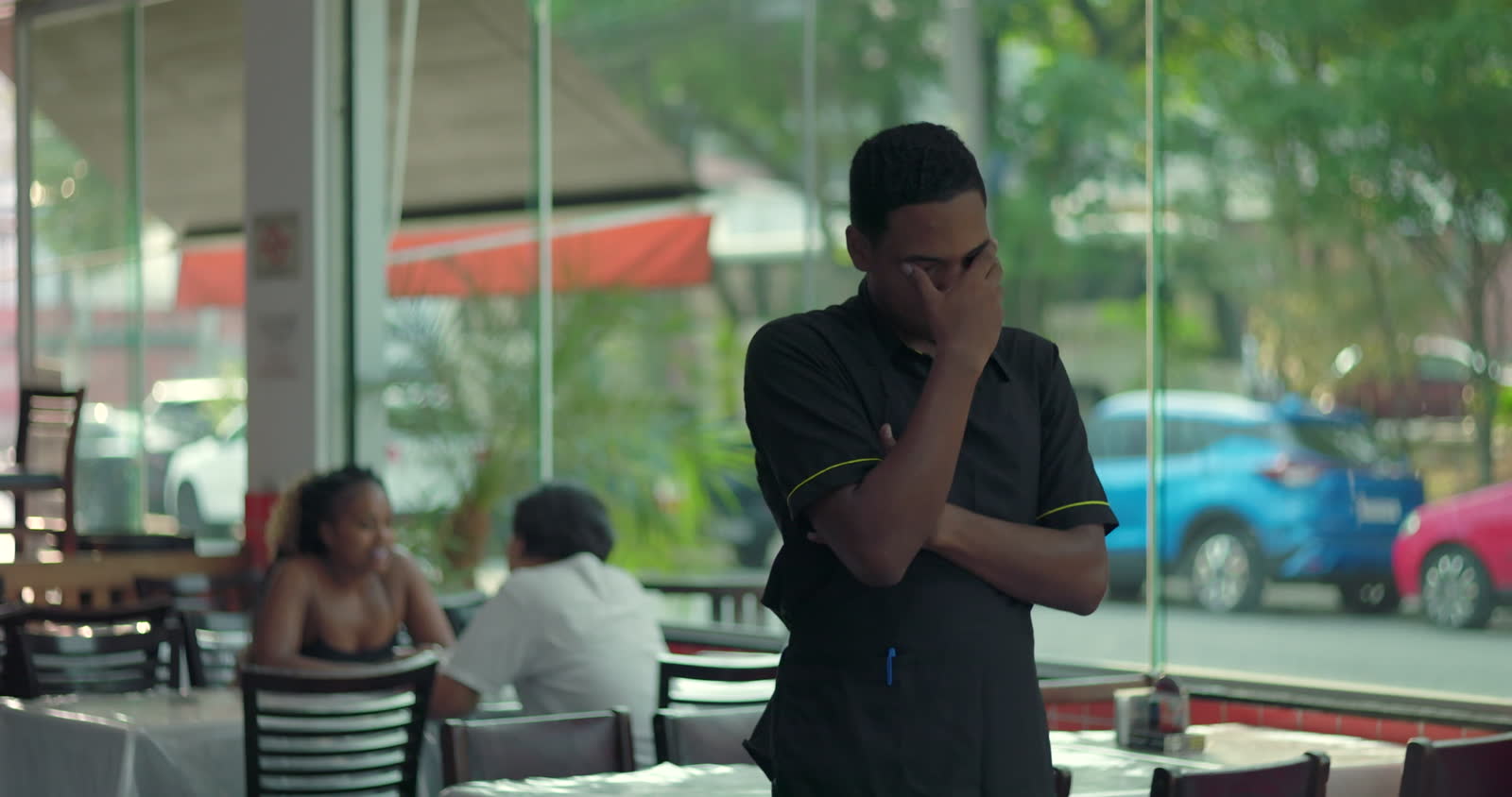 restaurant-worker-standing-with-hand-over-eyes-sh.mp4