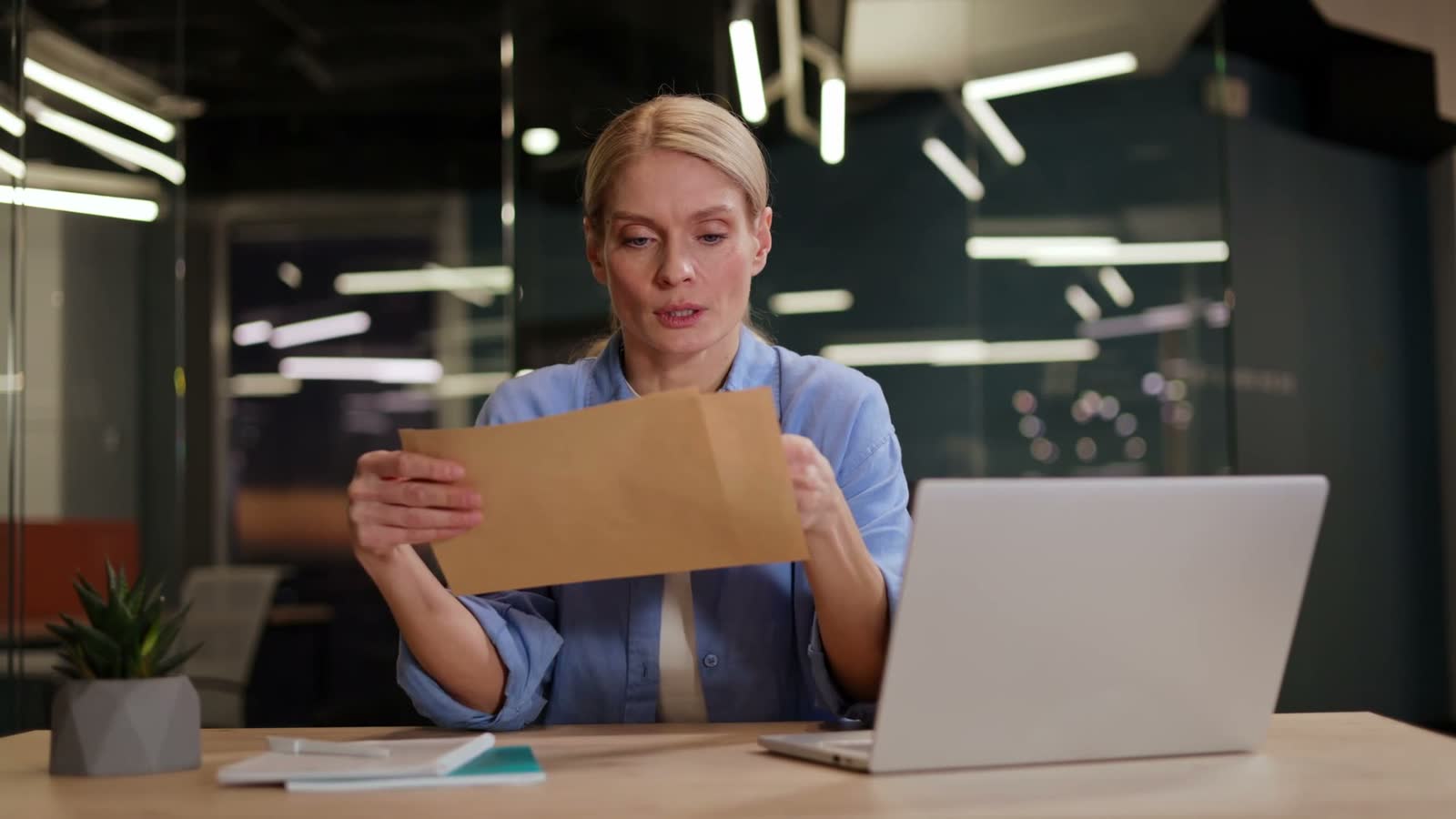 woman-reacts-badly-to-news-in-letter-at-office.mp4