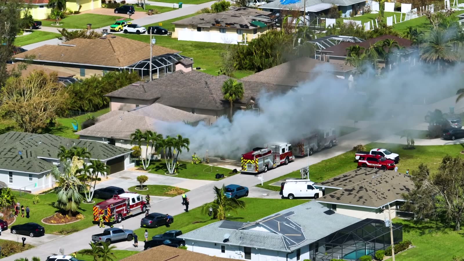 aerial-view-of-house-on-fire-and-firefighters-exti.mp4
