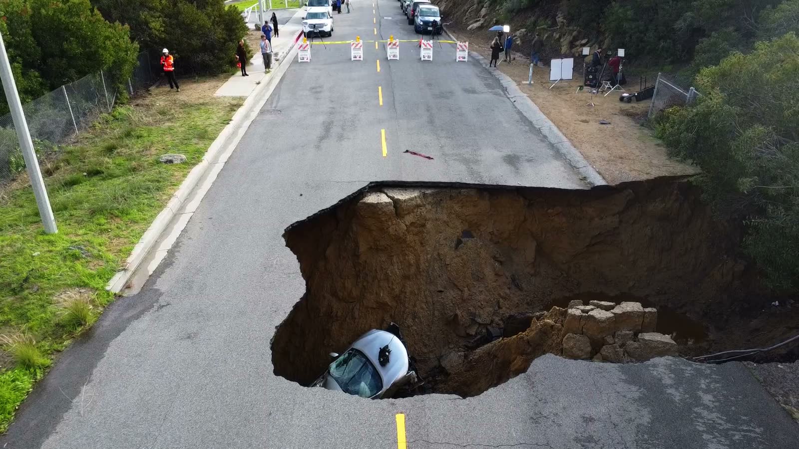 aerial-view-towards-a-car-in-a-sinkhole-sunny-day.mp4