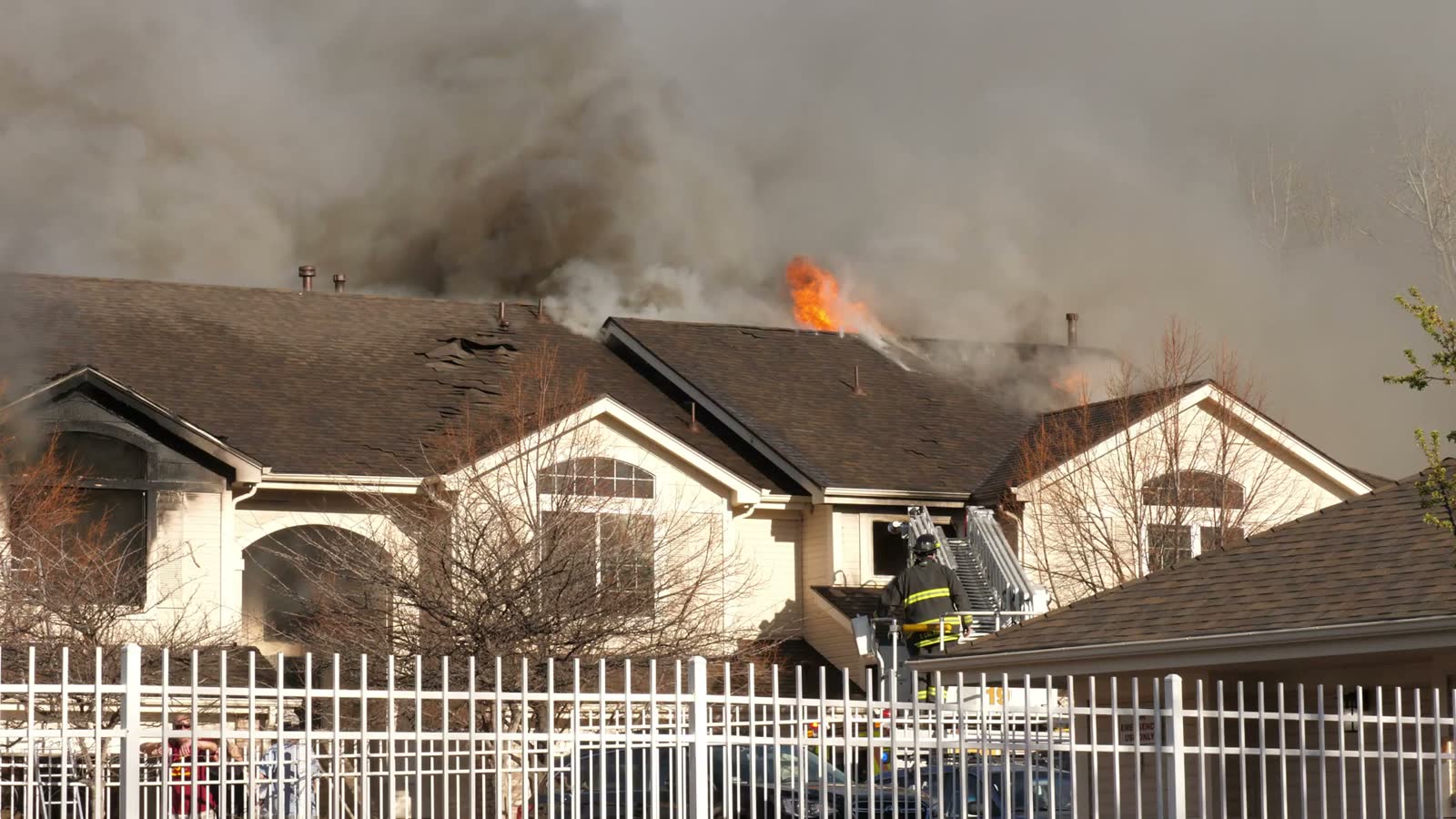 apartment-building-fire-with-firefighter-on-ladder.mp4