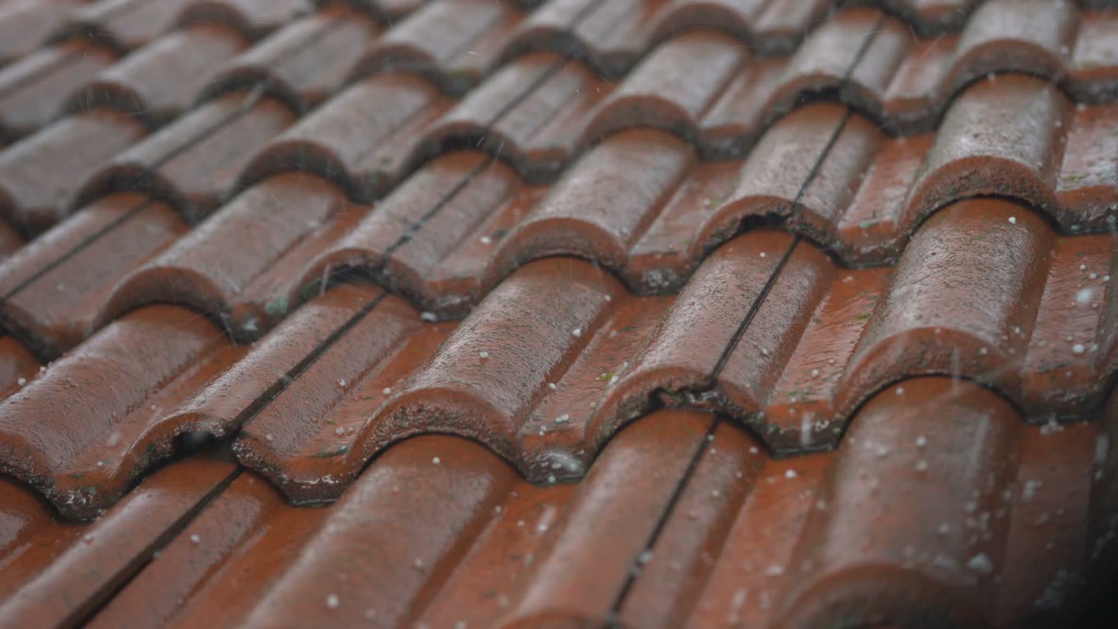 hailstones-falling-hard-on-red-tile-roof.mp4