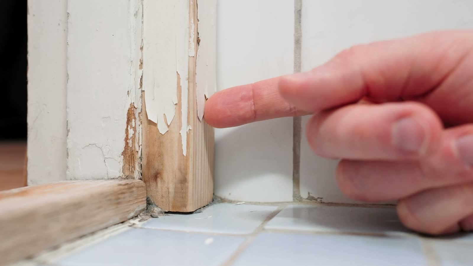 man-removing-chipped-paint-from-a-water-damaged-do.mp4