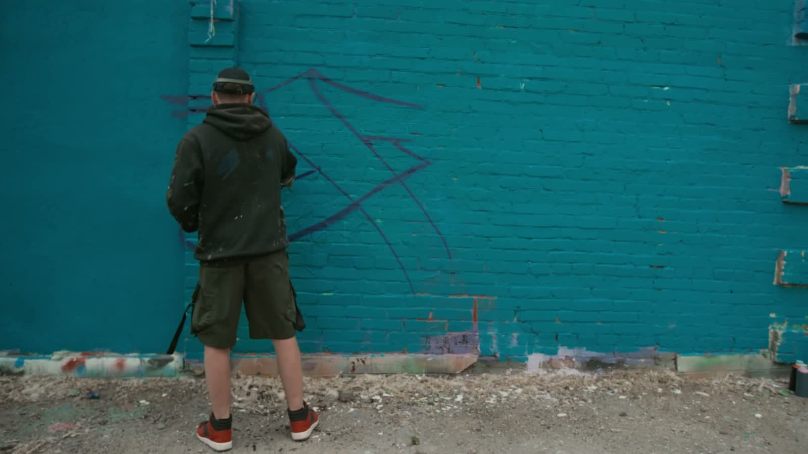young-adult-creating-graffiti-art-on-urban-wall.mp4