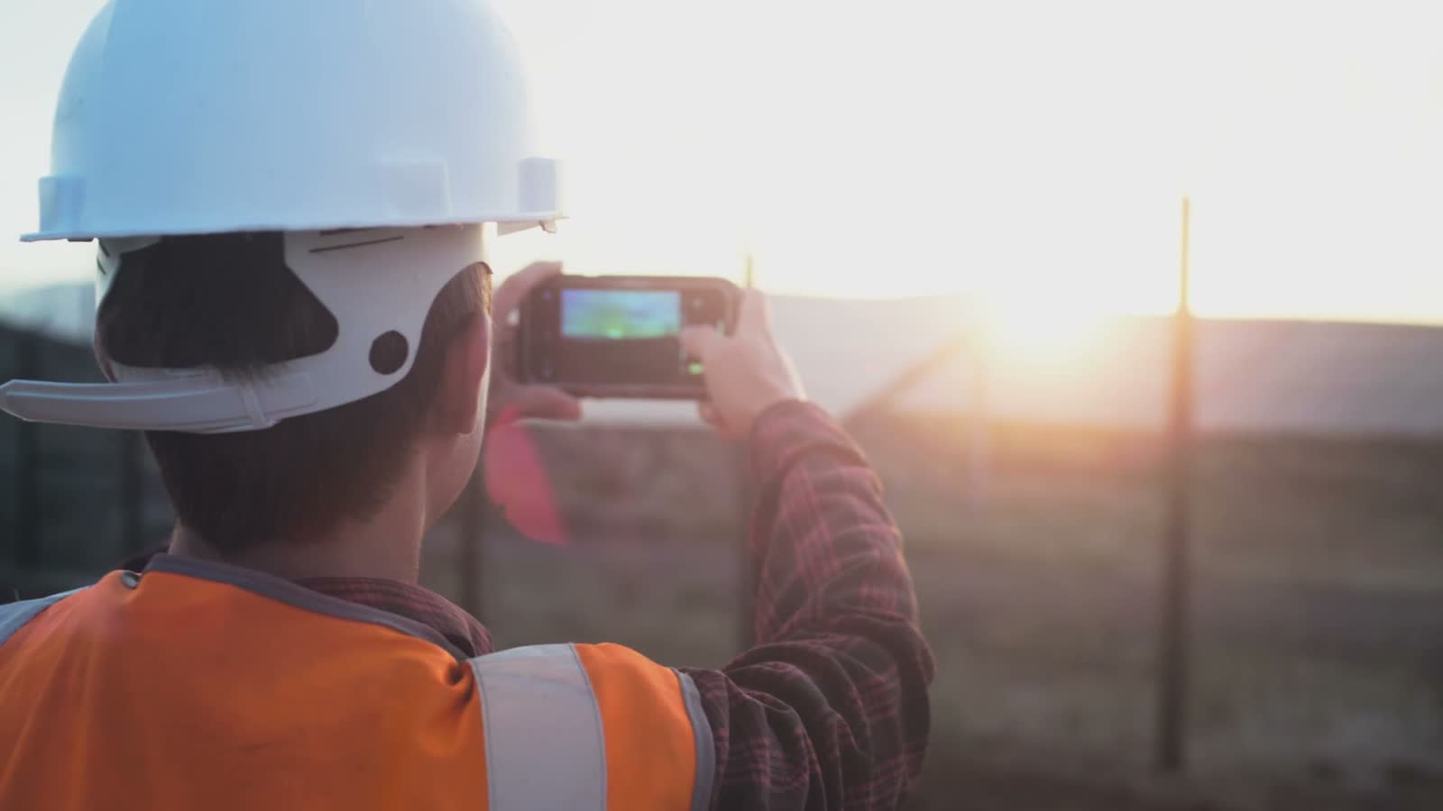 a-male-engineer-takes-a-photo-of-a-plantation-or-s.mp4