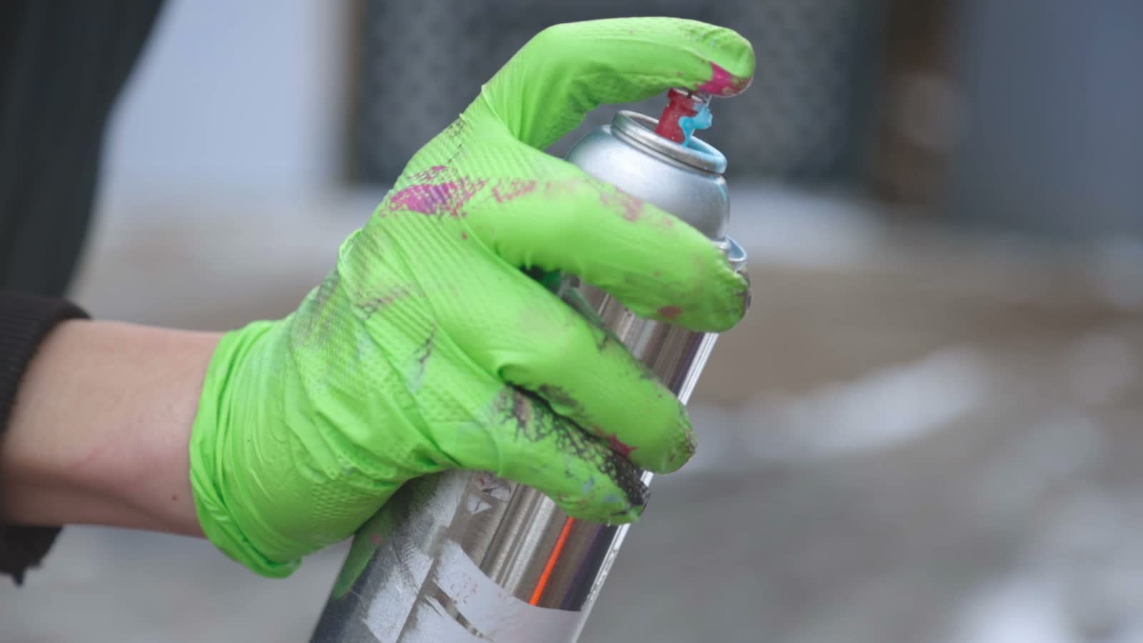 a-man-wearing-green-gloves-using-a-bottle-of-spray.mp4