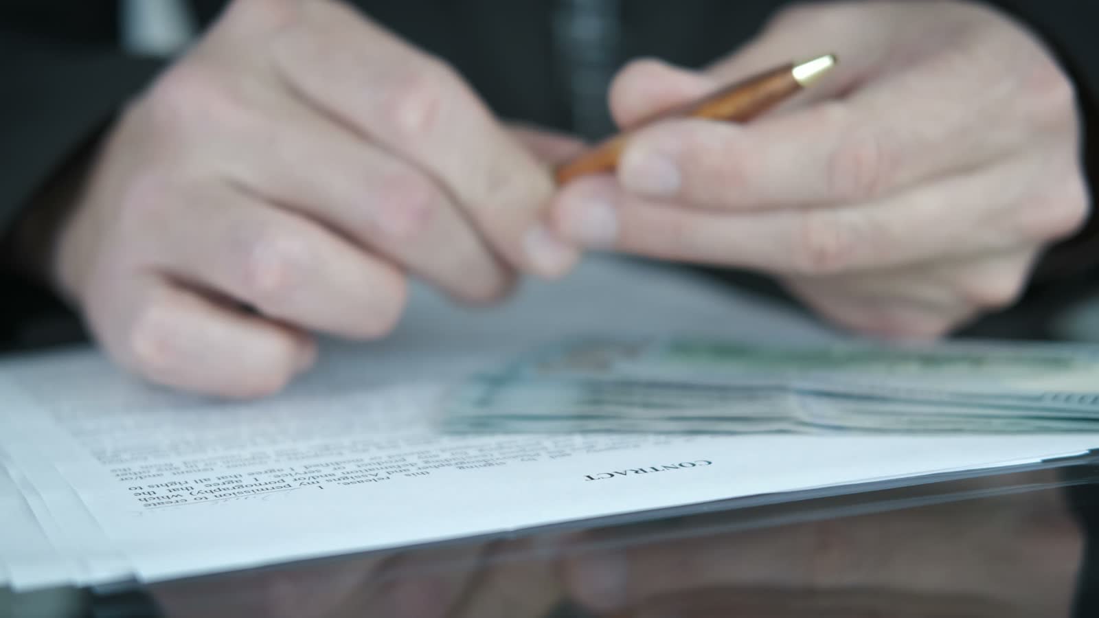 adult-signing-a-contract-with-money-nearby.mp4