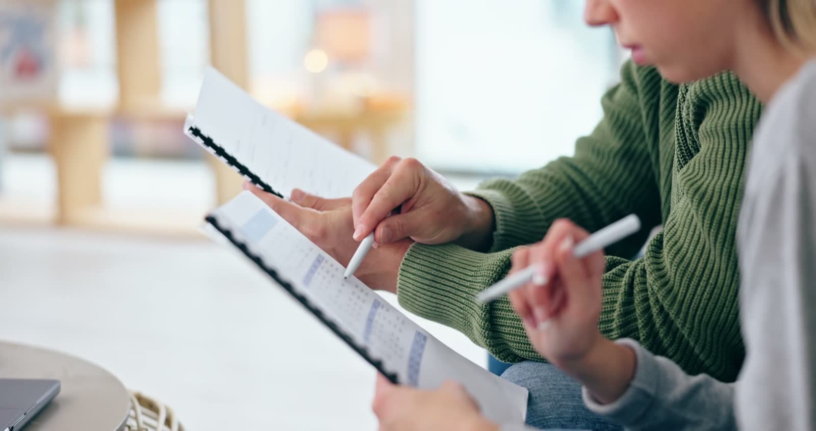 adults-review-documents-with-pens-in-bright-room.mp4