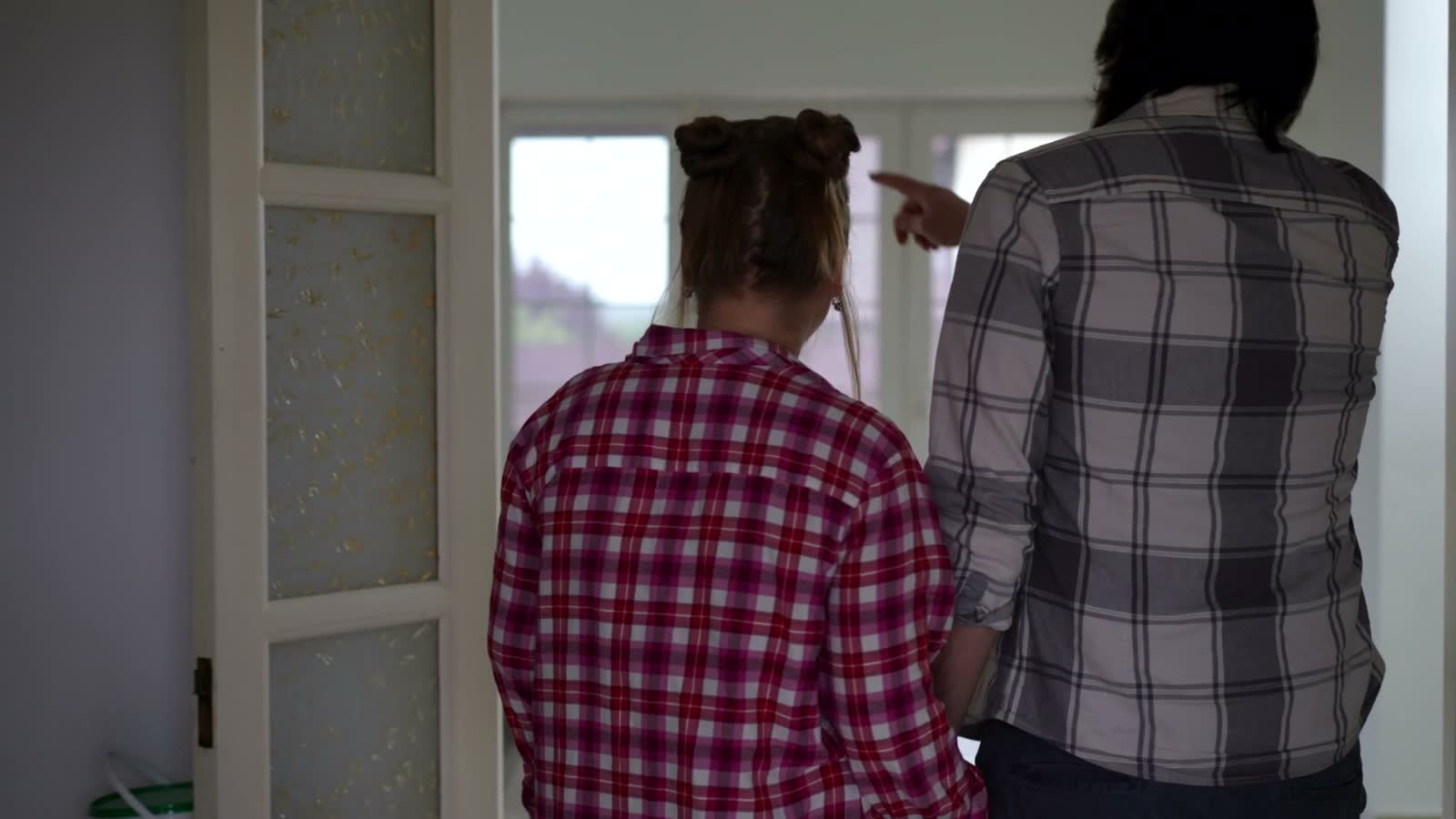 couple-holding-hands-exploring-new-house.mp4