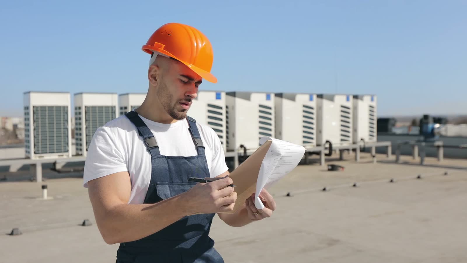 engineer-inspecting-air-conditioning-units-on-a-ro.mp4