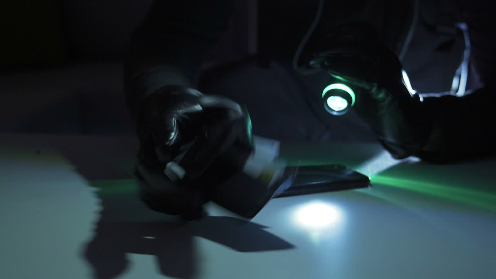 figure-stealing-cash-and-phone-at-night.mp4