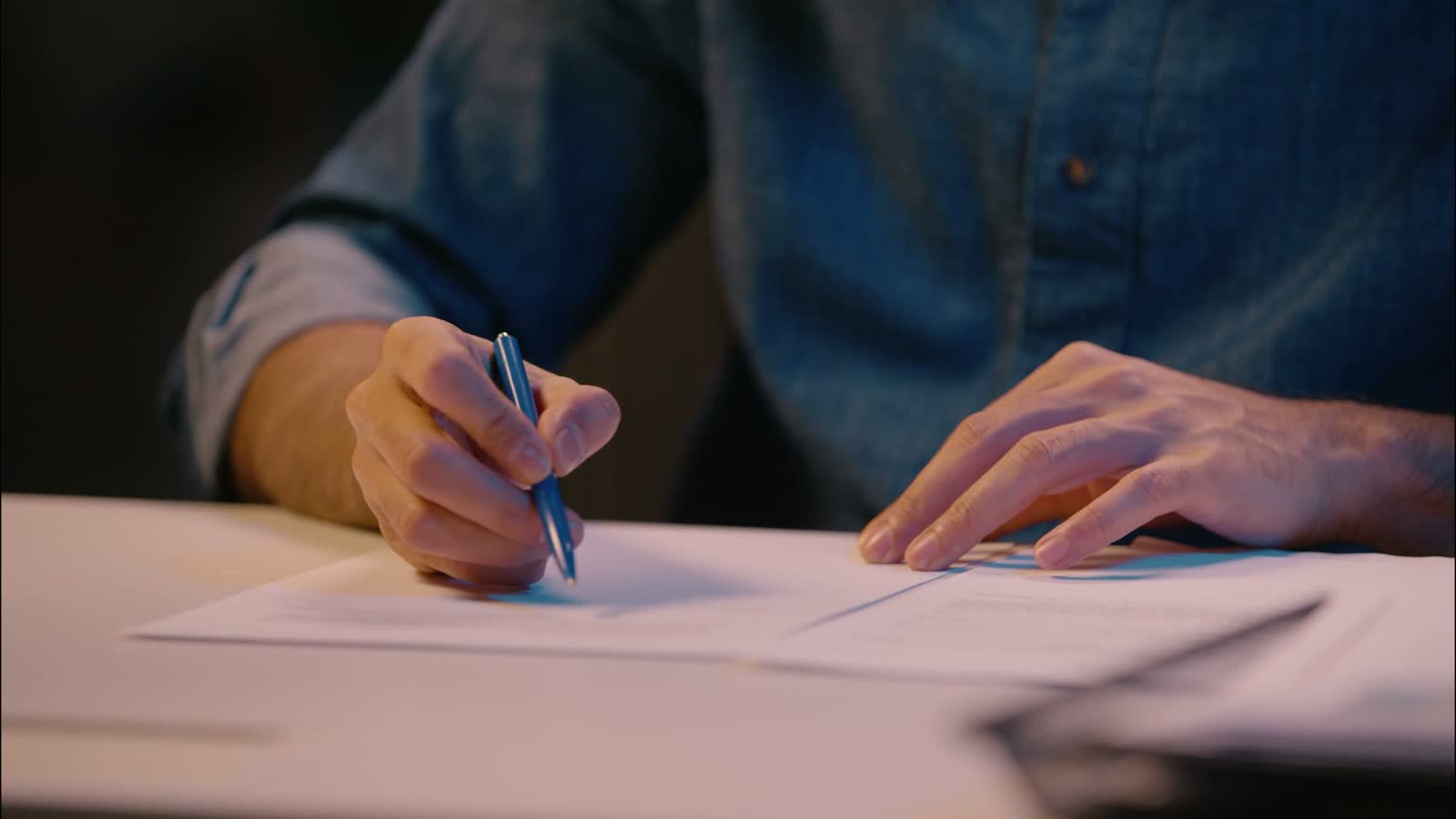 indian-man-businessman-writing-on-table-night-offi.mp4