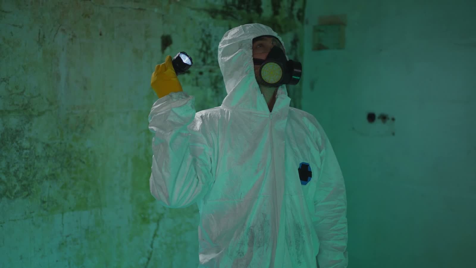 man-in-hazmat-suit-holding-flashlight.mp4