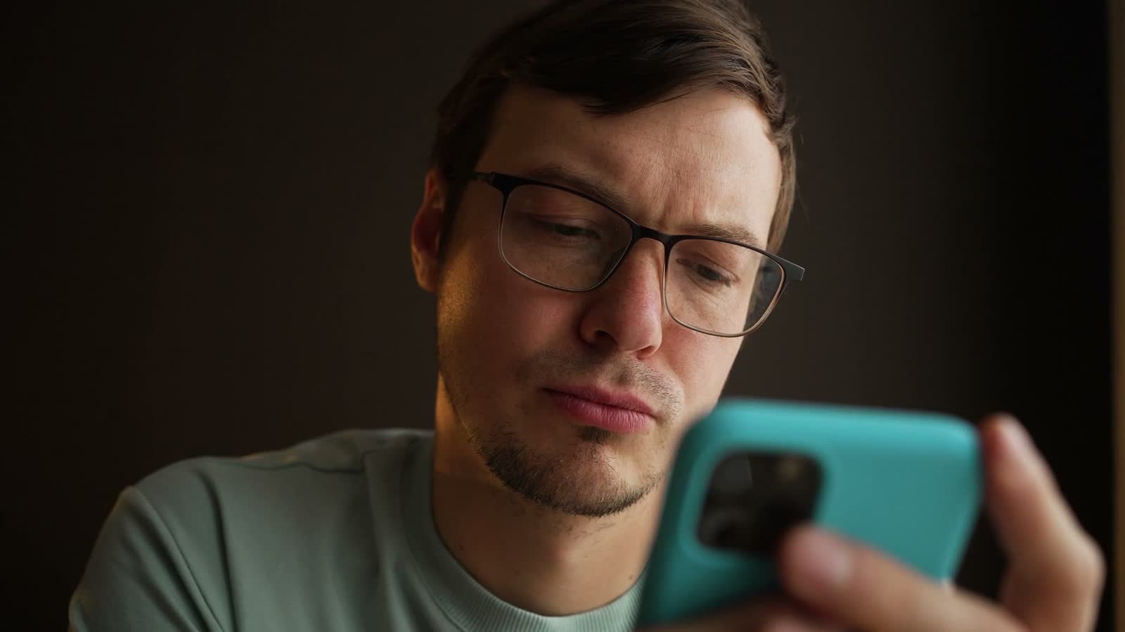 man-looking-at-smartphone-indoors-close-up.mp4