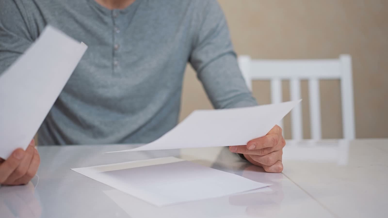 man-signs-document-at-white-table-indoors.mp4