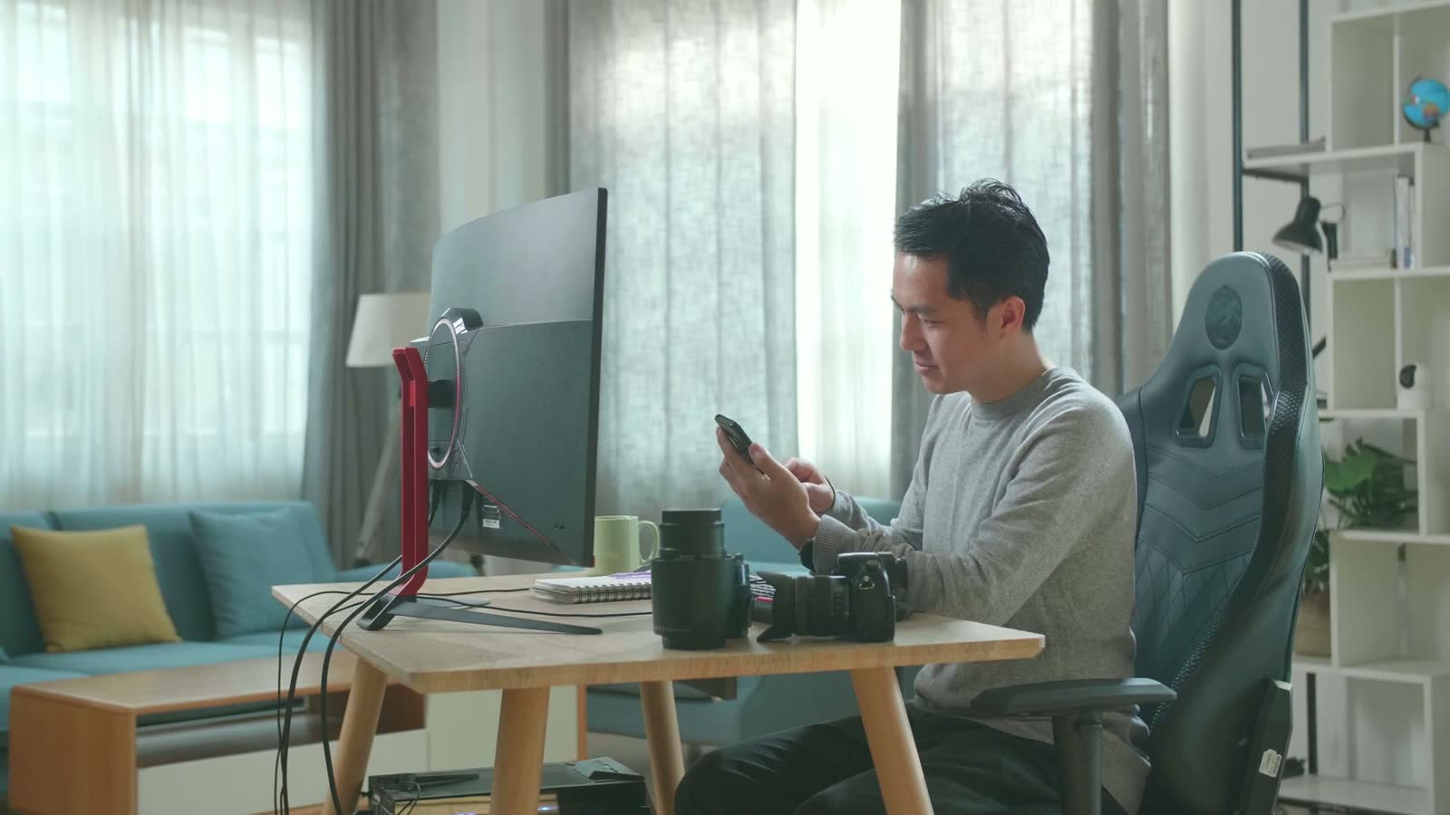 man-using-smartphone-at-desk-with-computer.mp4