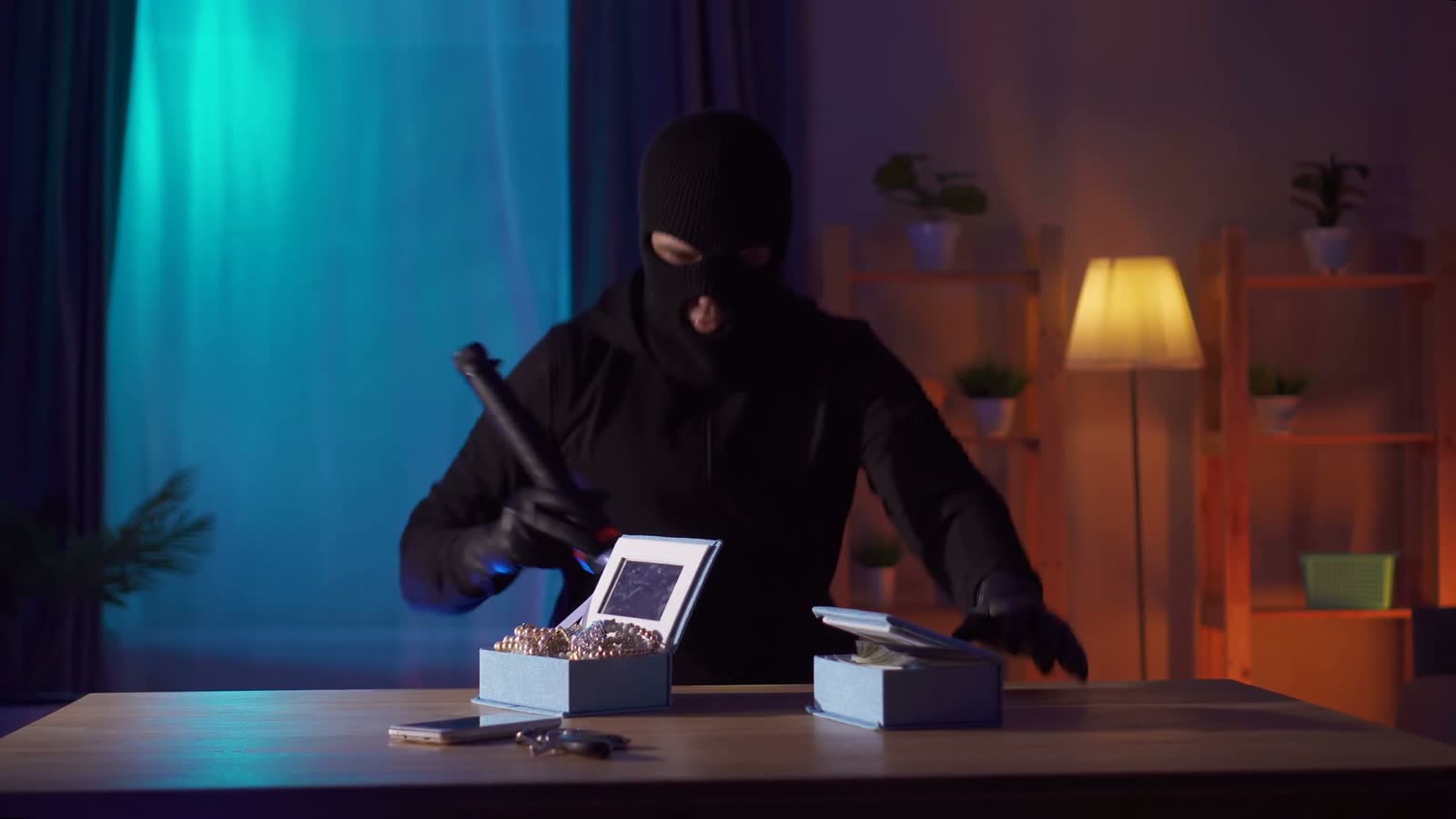 masked-person-holding-jewelry-and-money-indoors-at.mp4