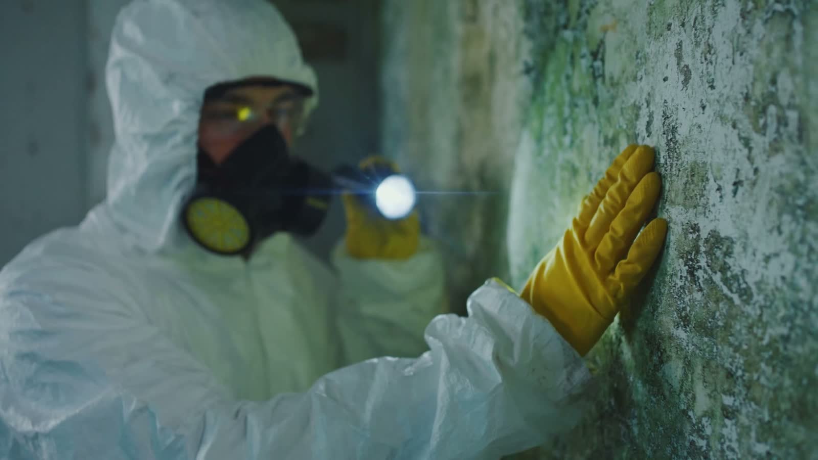person-inspecting-damaged-wall-in-hazmat-suit.mp4