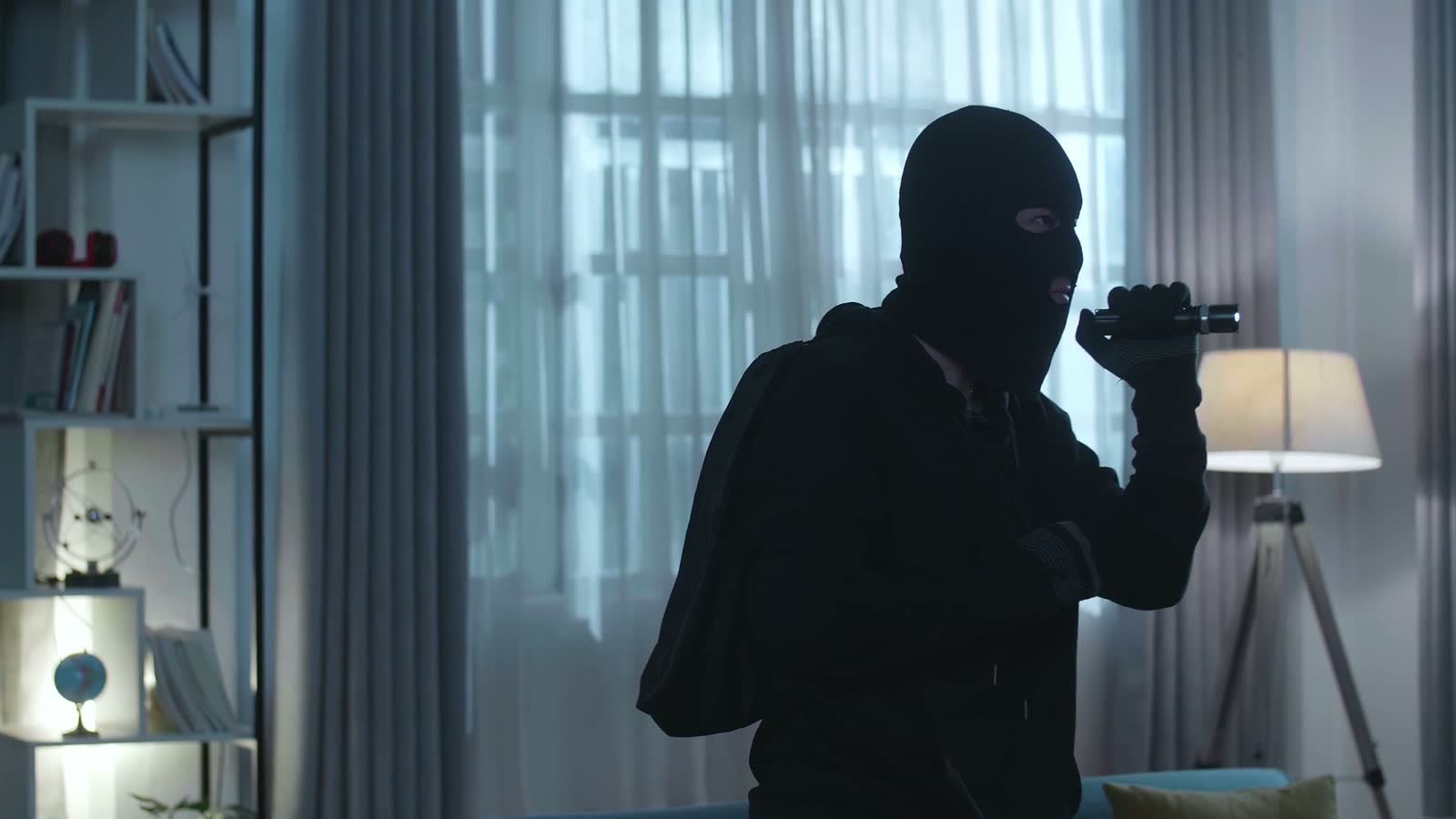 person-with-flashlight-and-ski-mask-indoors-at-nig.mp4