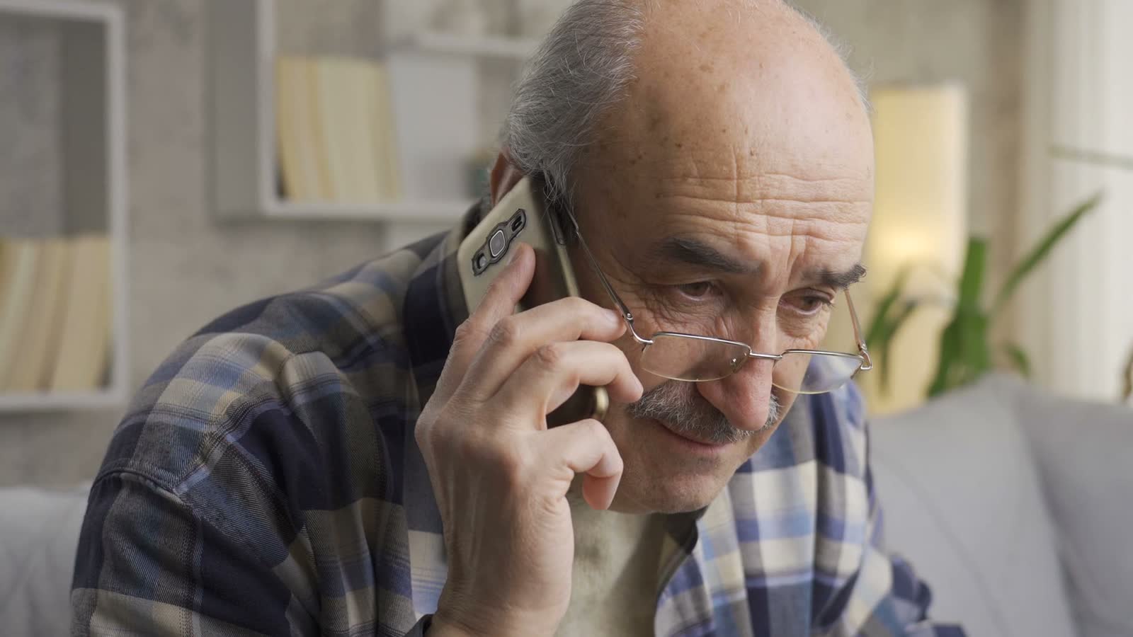 senior-man-talking-on-smartphone-indoors.mp4
