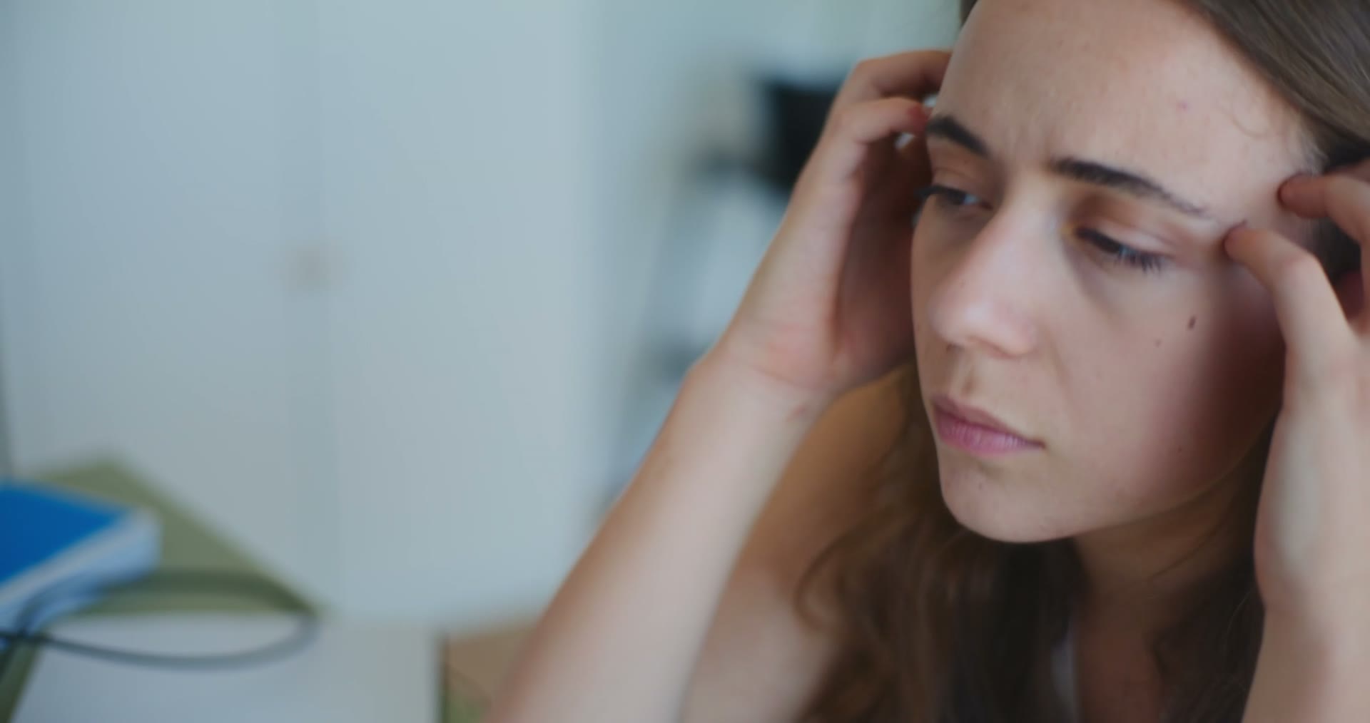 stressed-woman-massaging-head-in-close-up.mp4