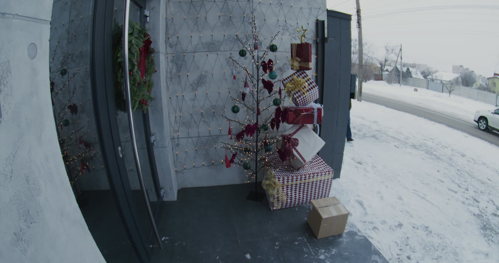 woman-picking-up-a-delivery-package-from-porch-dur.mp4