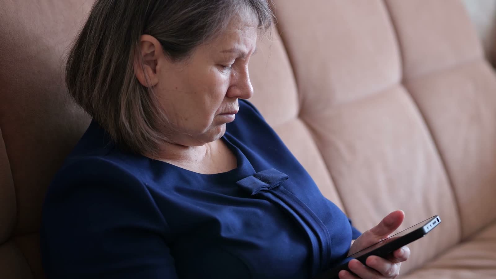 woman-using-smartphone-on-sofa-indoors.mp4