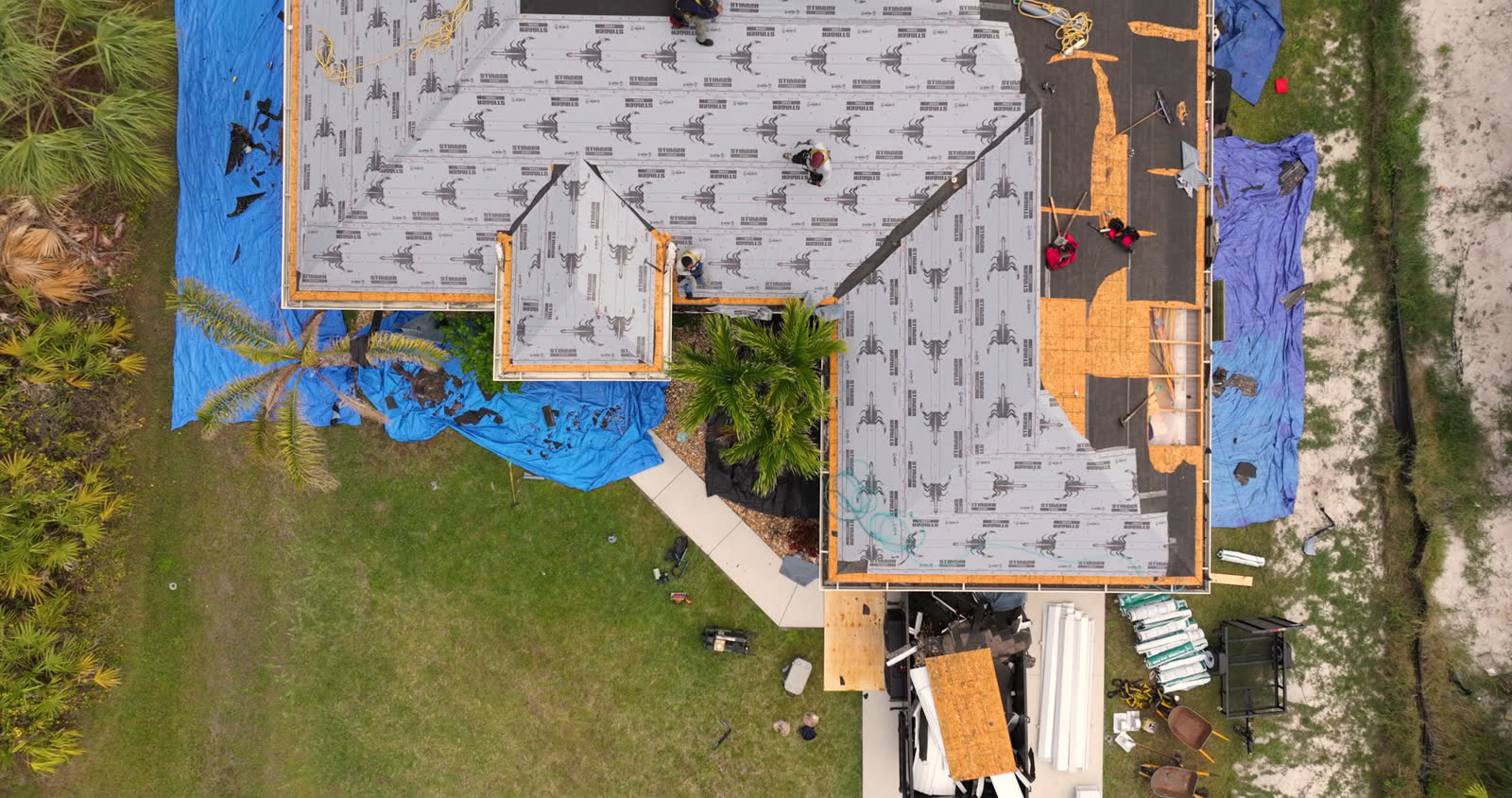 aerial-view-of-home-roof-repair-with-workers.mp4