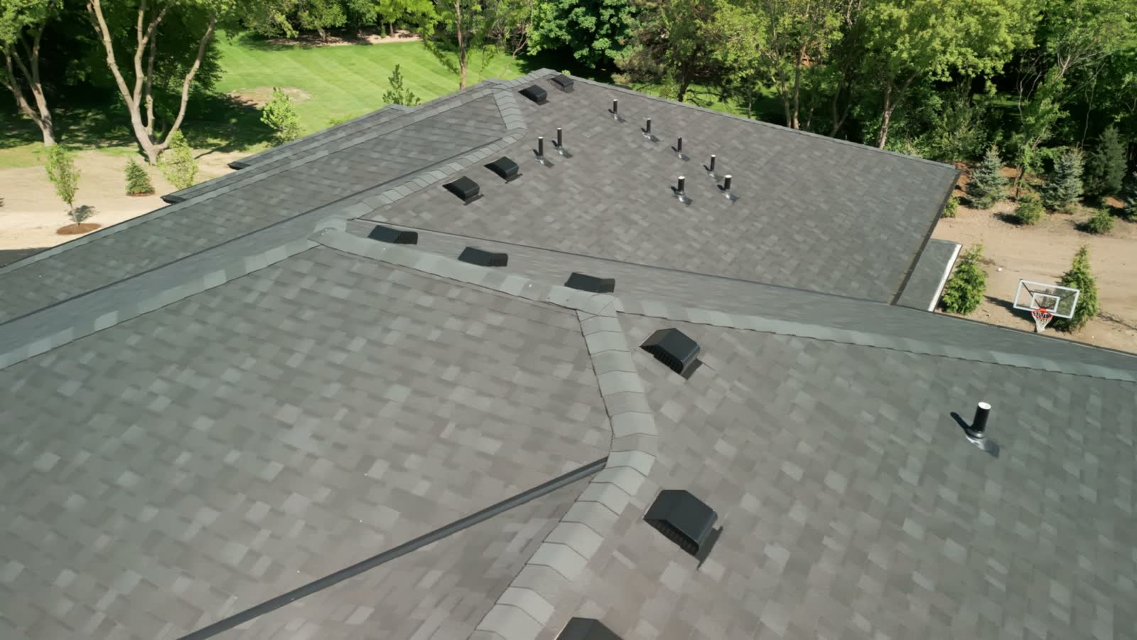 Aged but intact shingle roof with uniform weathering across every slope