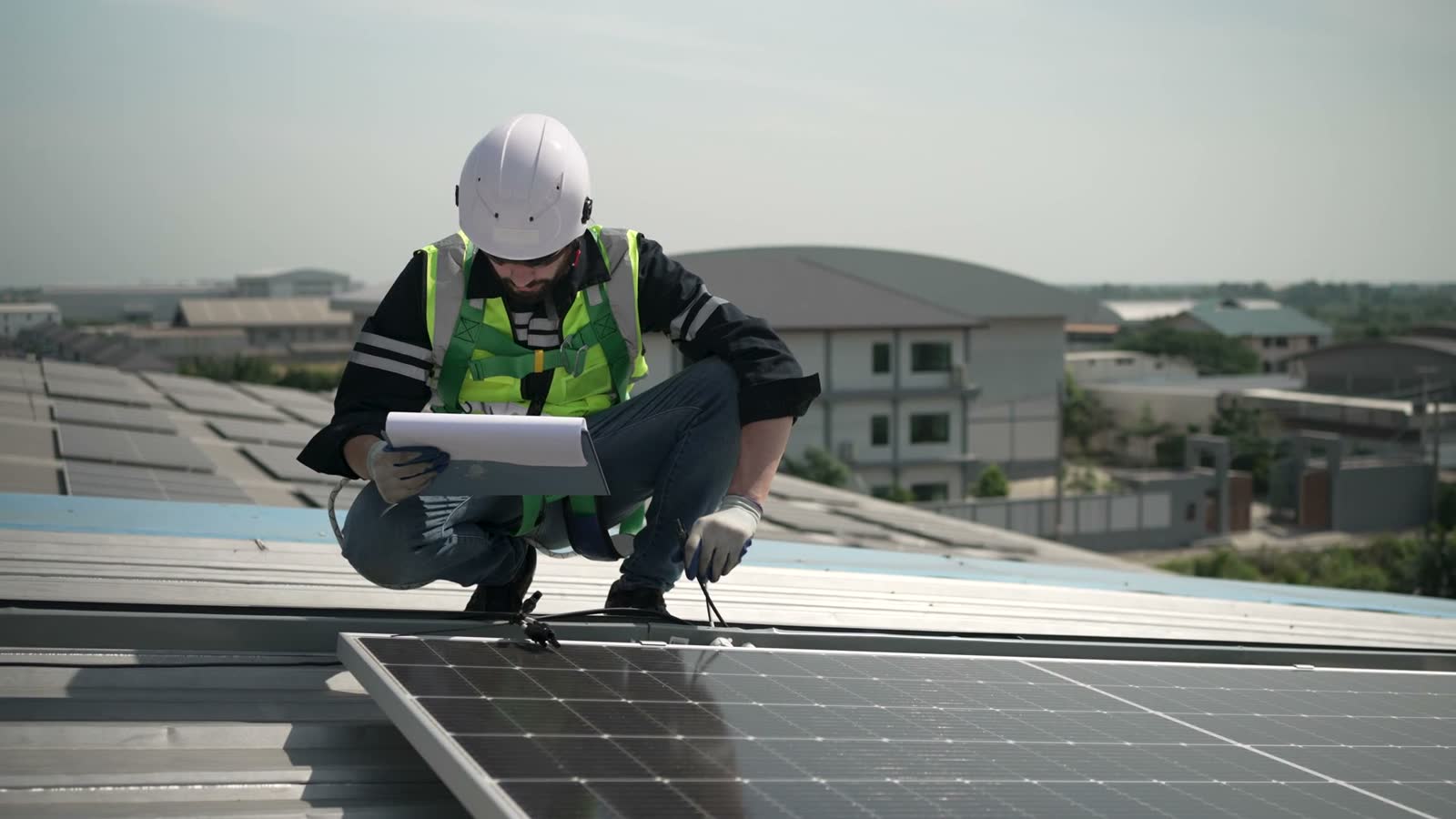 blue-collar-worker-is-inspecting-solar-panel-at-ro.mp4