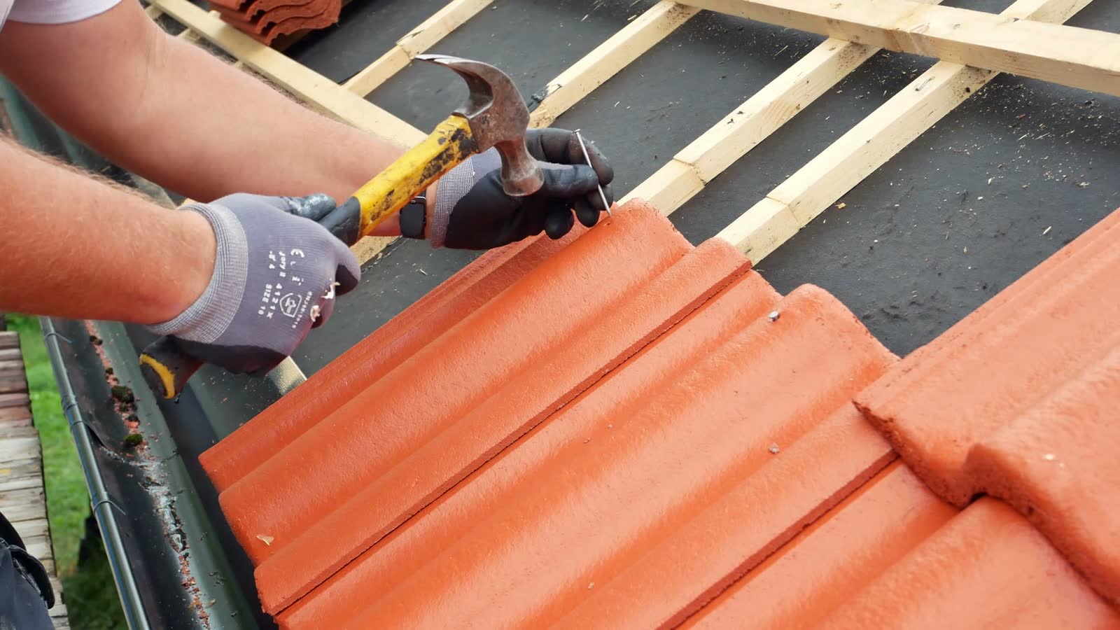 construction-worker-installing-clay-roof-tiles-wit.mp4