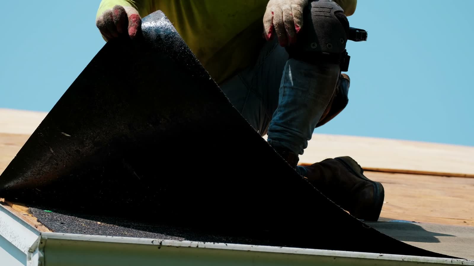 construction-worker-installing-roofing-material-on.mp4